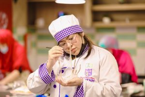 A culinary arts student is busy in cake decoration at COTHM