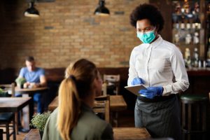 A waitress taking order from a customer at a restaurant. Image source: Shutterstock